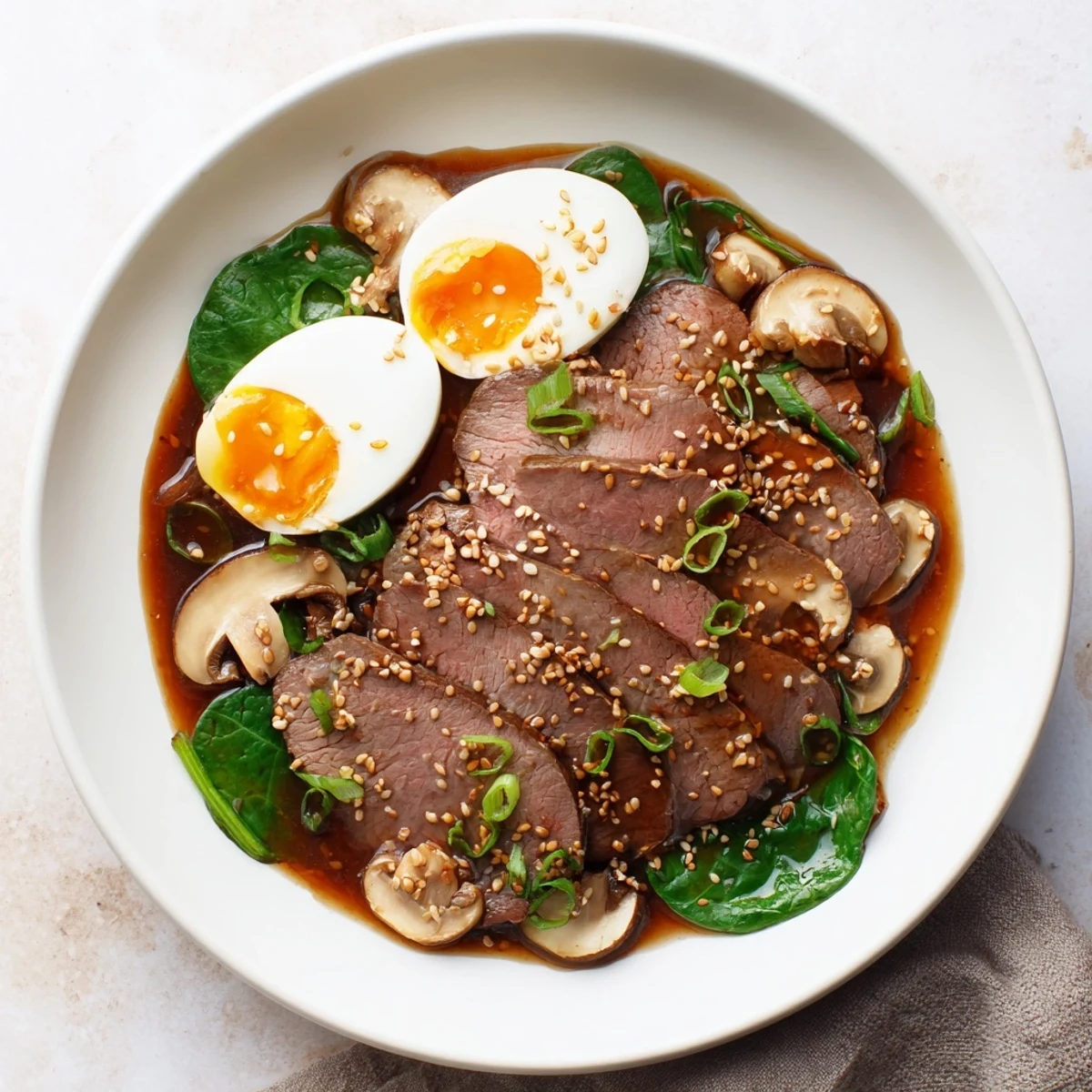 Steaming bowls of Spicy Beef Ramen with a perfectly soft egg and vibrant garnishes, ready to eat.