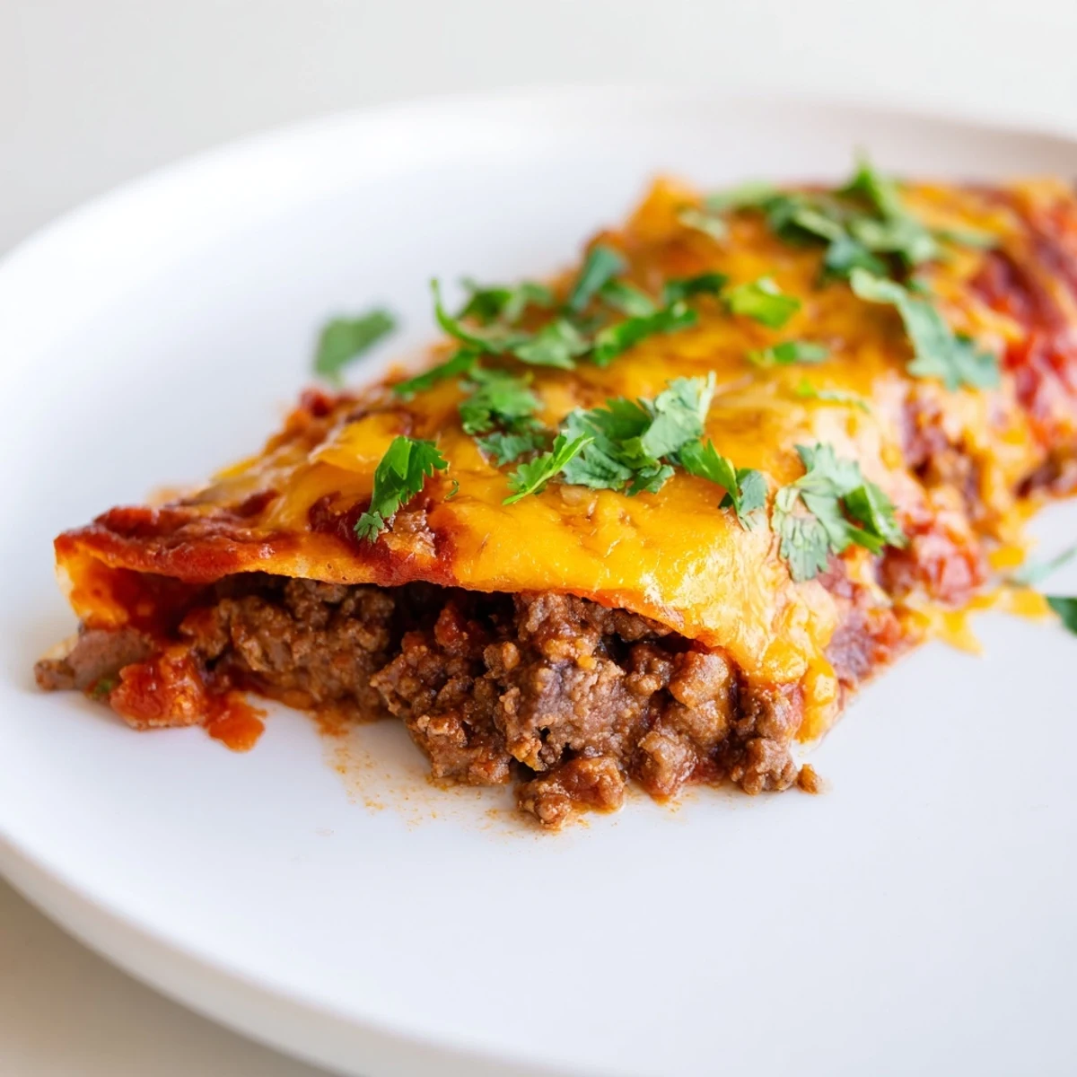 Golden-brown Beef Enchiladas with Homemade Sauce are baked until bubbling with melted cheese.