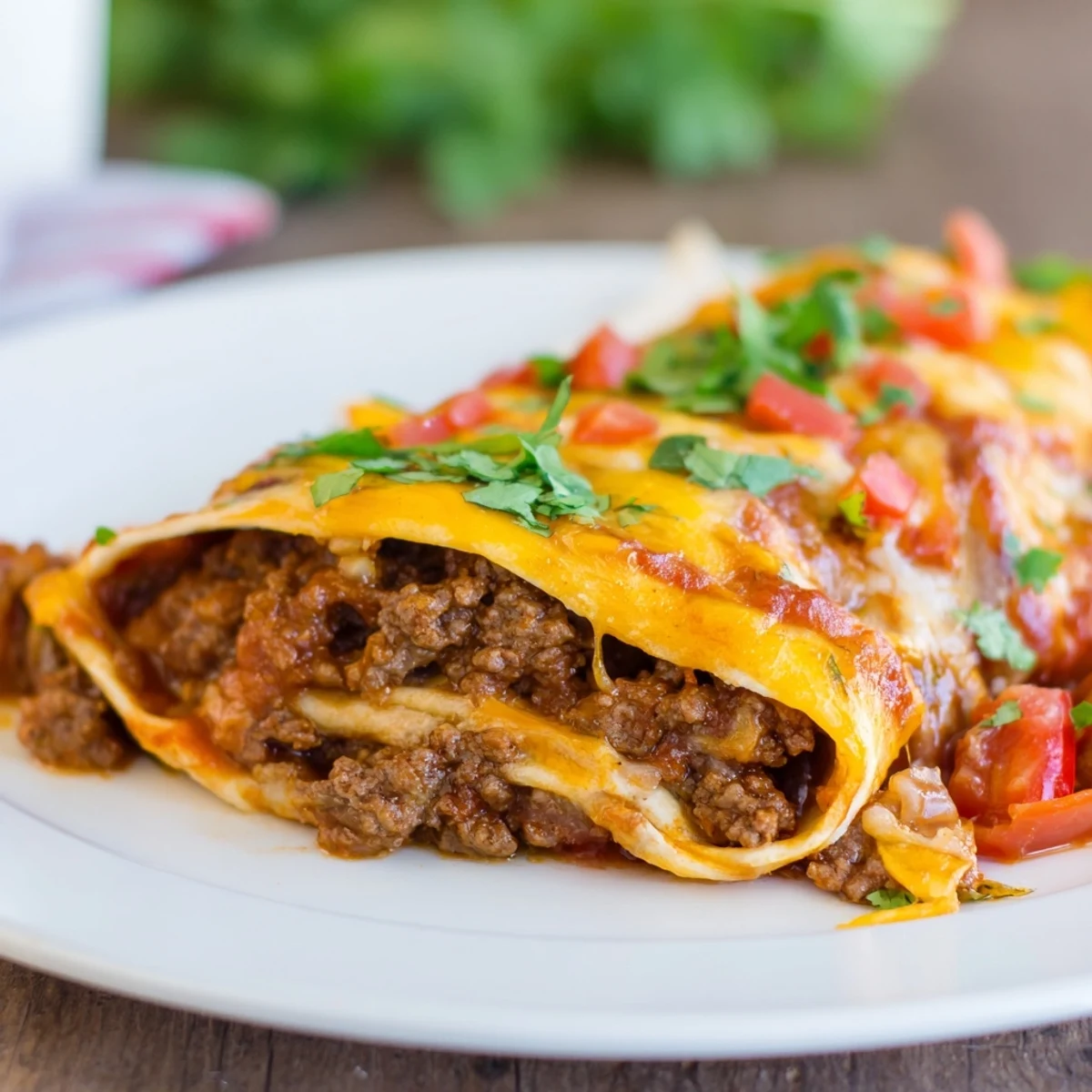 Fresh cilantro and sliced jalapeños garnish the zesty enchiladas with homemade sauce.