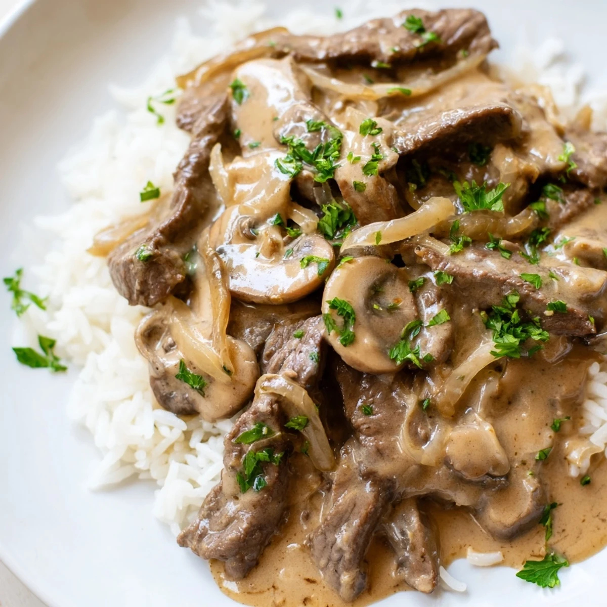 Beef Stroganoff with Basmati Rice topped with tender beef and mushrooms in a creamy sauce.