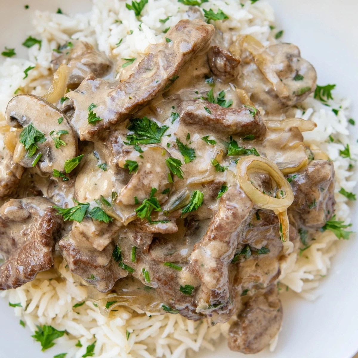 Golden Beef Stroganoff with Basmati Rice plated for a cozy dinner with a rustic spoon.