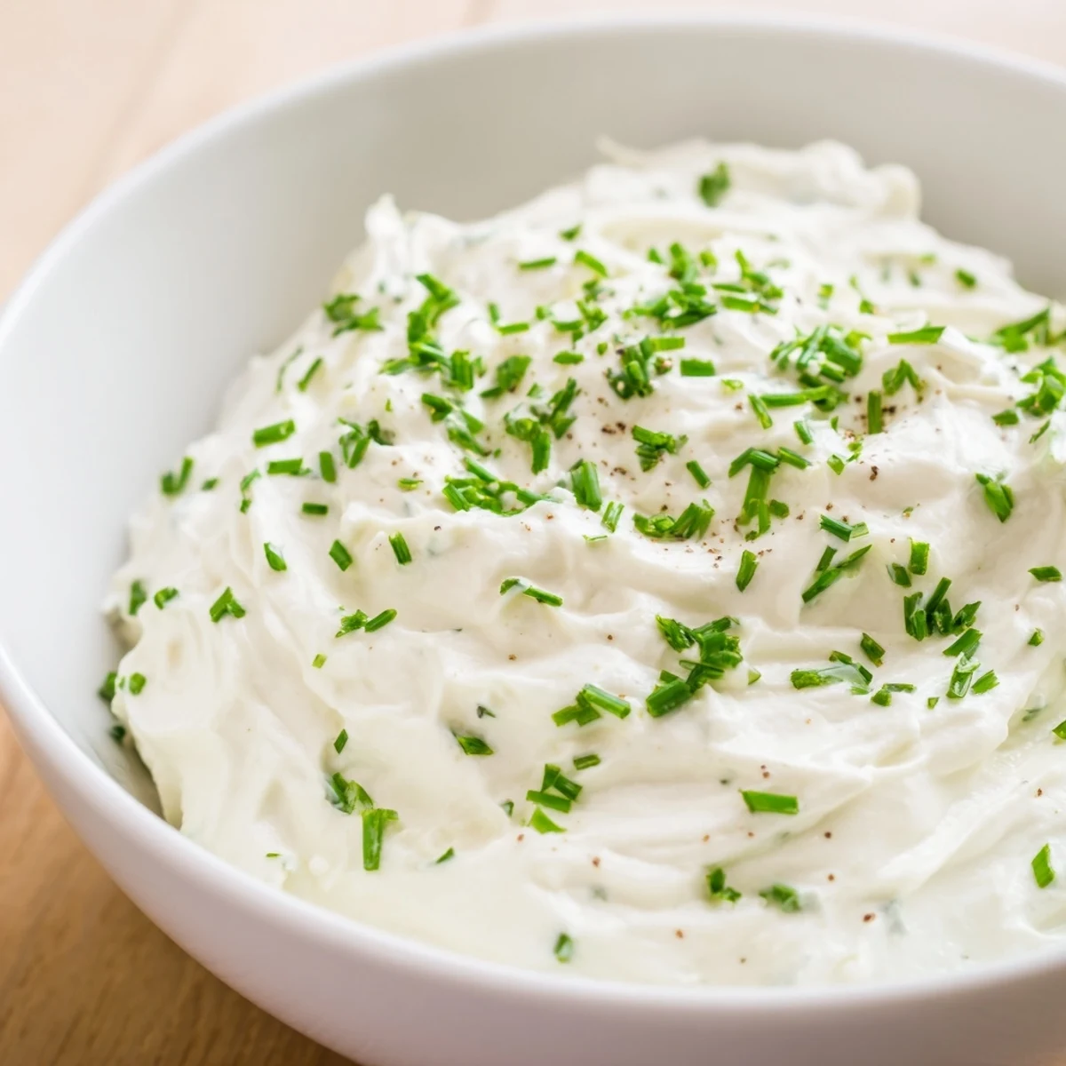 A bowl of Creamy Dip Bowl on a rustic wooden table, featuring a sprinkle of smoked paprika and ready for a party snack platter.