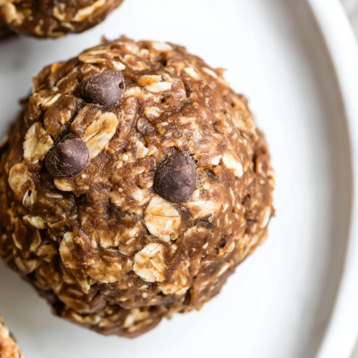 Homemade Chocolate Peanut Butter Energy balls on a marble counter next to a cup of coffee.