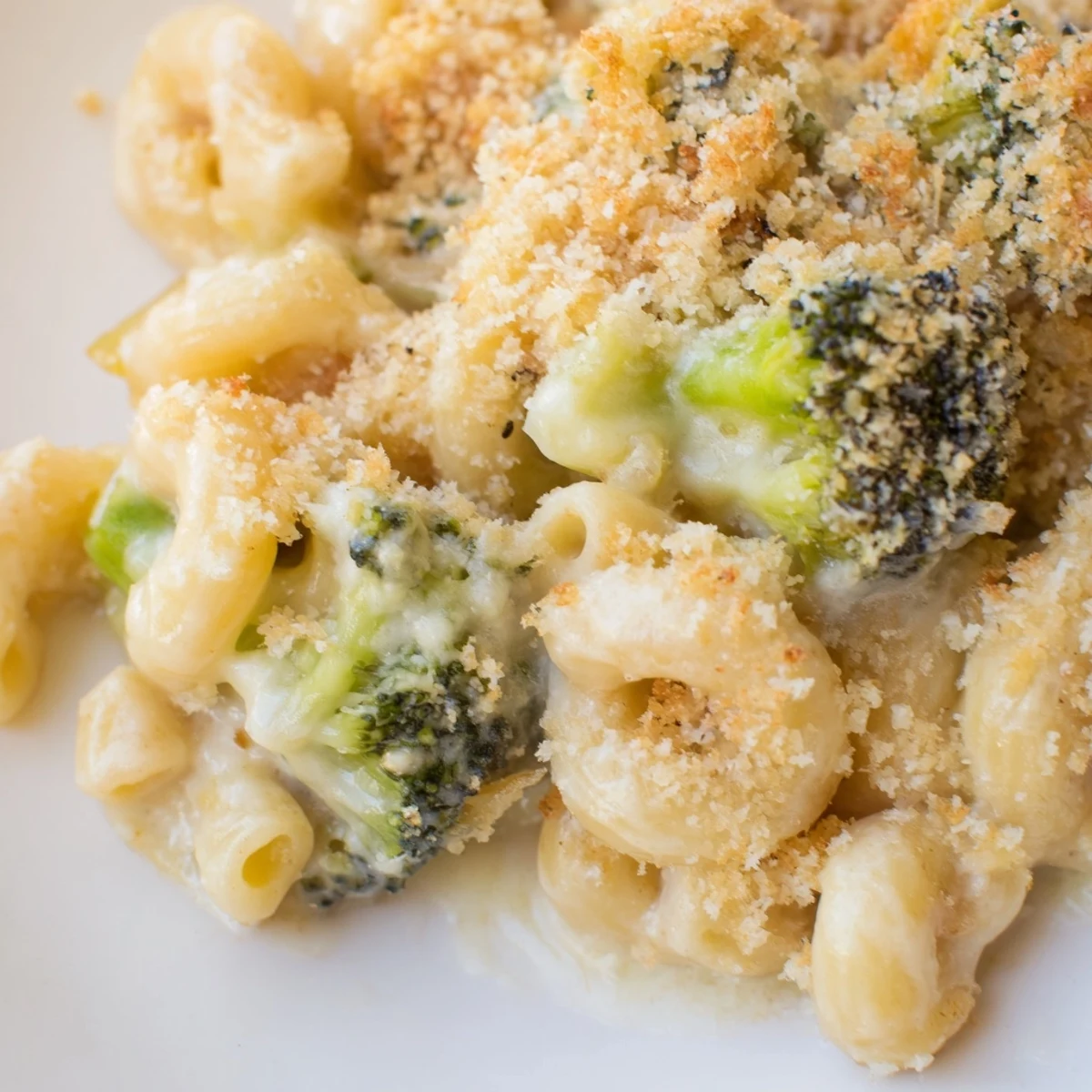 A 2.5-quart baking dish of homemade baked macaroni and cheese with broccoli, served warm as a comforting family dinner main dish.