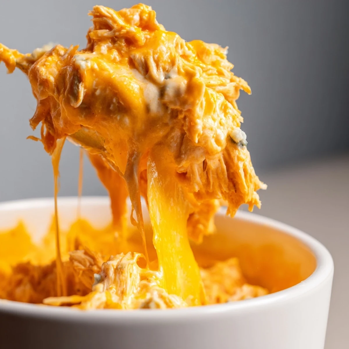 Freshly baked Buffalo Chicken Dip with celery sticks and tortilla chips for dipping, hot and bubbly.