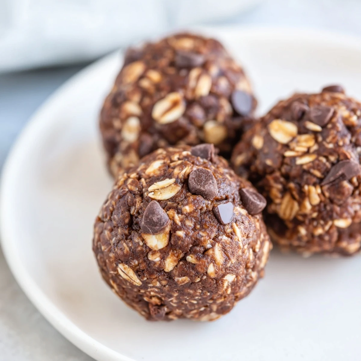 Platter of chocolate peanut butter energy balls served alongside coffee for a post-workout snack.