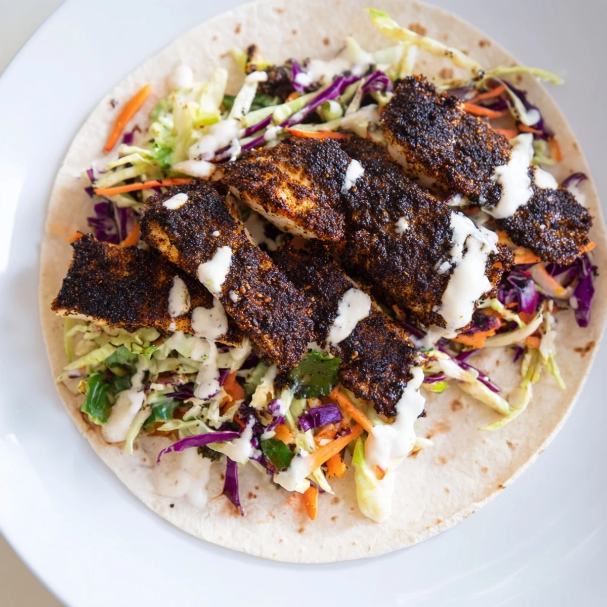 Louisiana Blackened Fish Tacos feature smoky spices on flaky fish nestled in soft corn tortillas.  