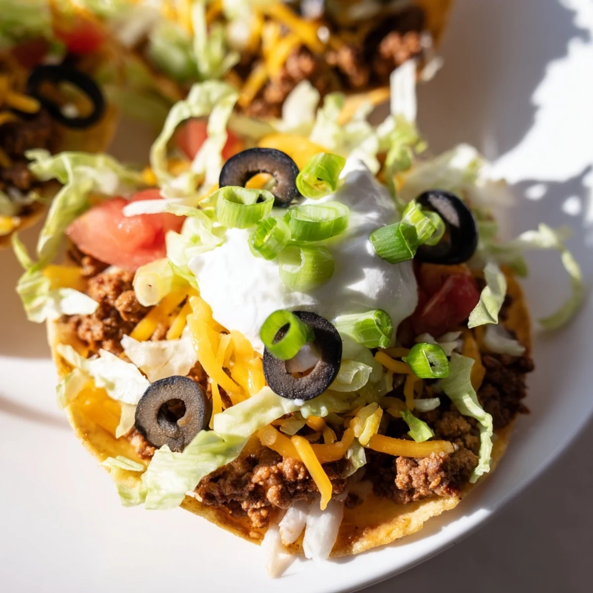 Sizzling seasoned ground beef is spooned into warm tortilla cups, topped with shredded cheese and baked until golden and bubbly.