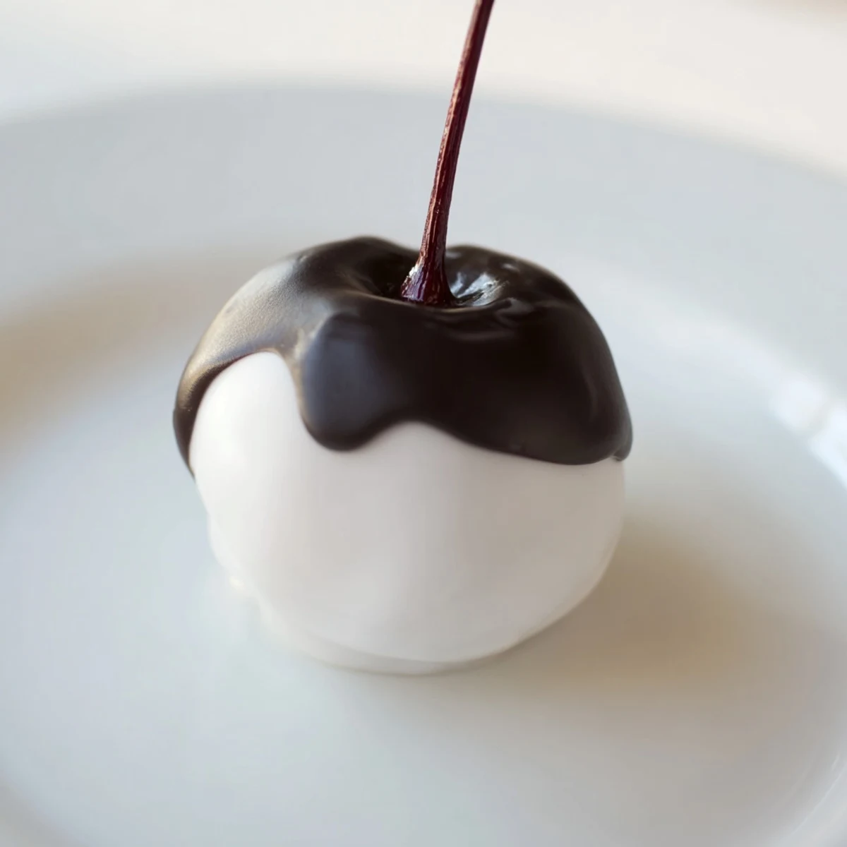 Handmade Chocolate Covered Cherries with Fondant showing a white fondant layer under glossy chocolate.