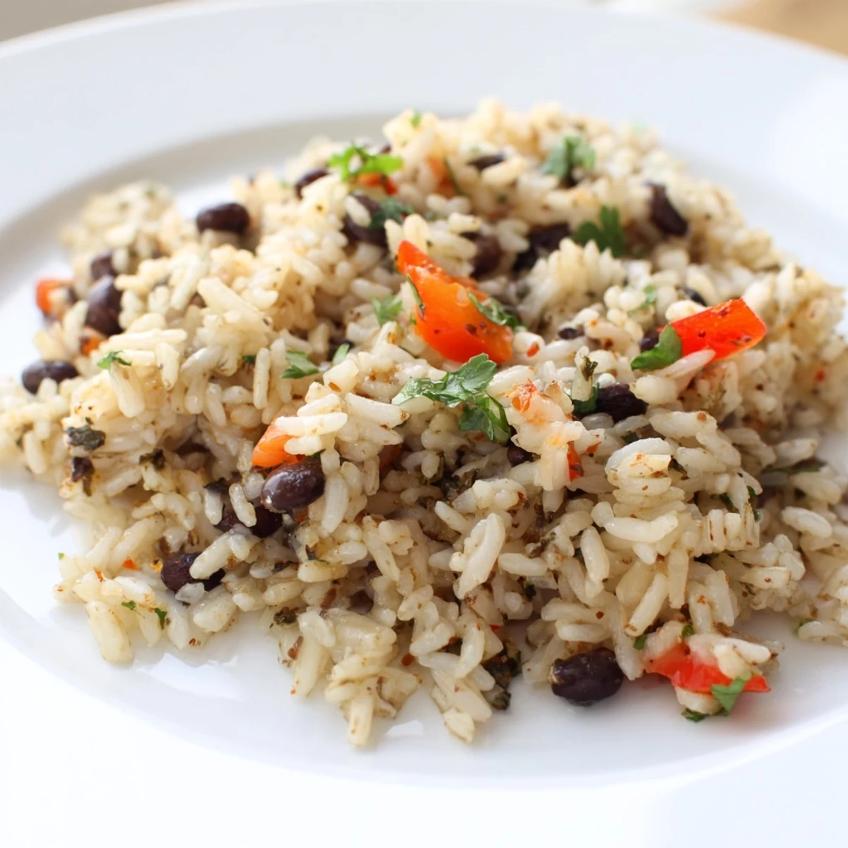 Easy one-pot rice and beans recipe, a hearty vegan main course with colorful peppers and onions.
