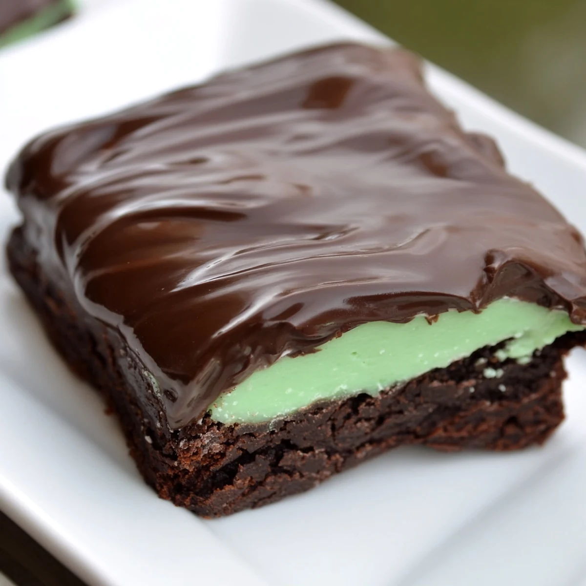 Decadent Green Mint Brownies cut into pieces, perfect for dessert with a glass of cold milk.