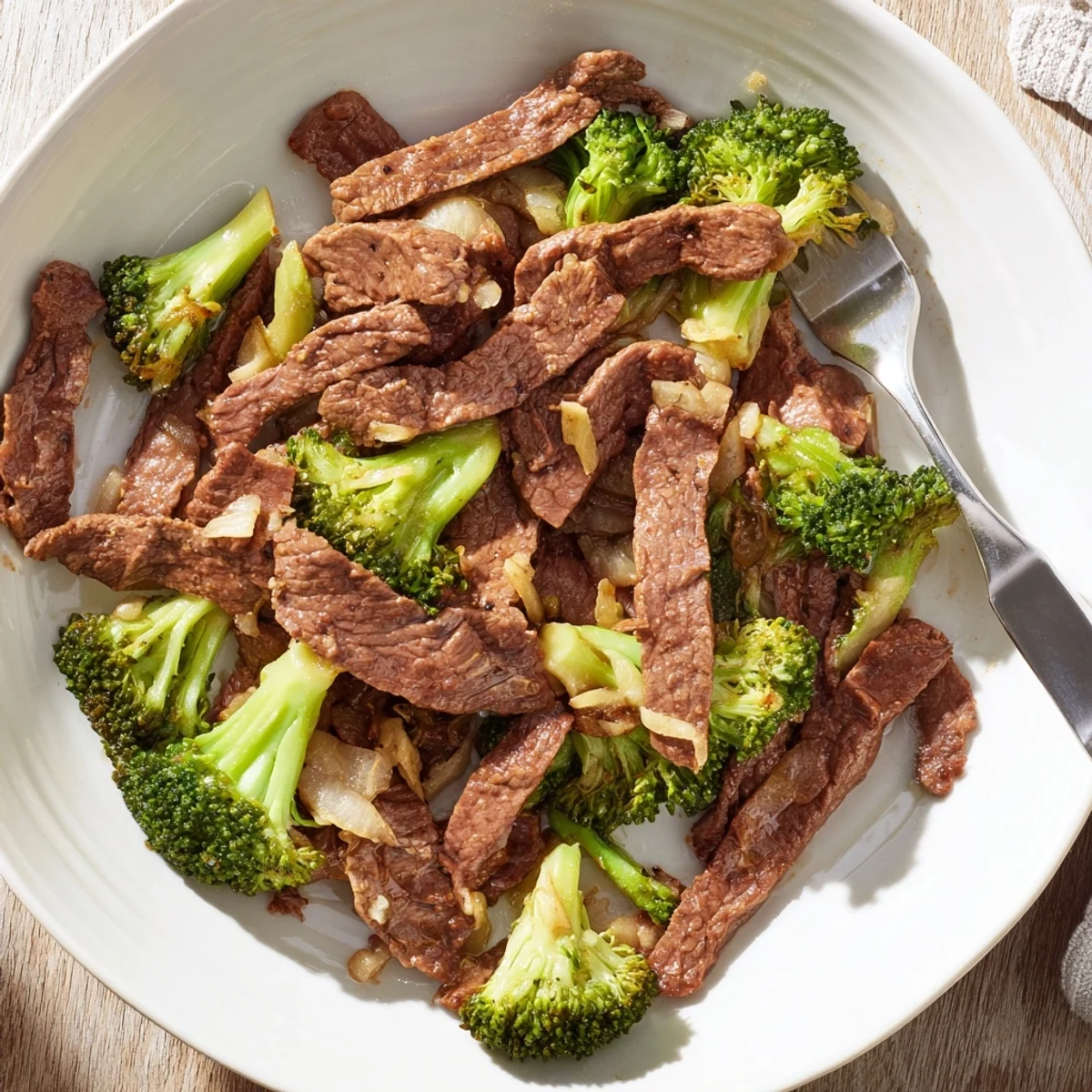 Tender beef strips and crisp broccoli florets glisten in a savory soy sauce glaze in this Beef and Broccoli stir-fry.  