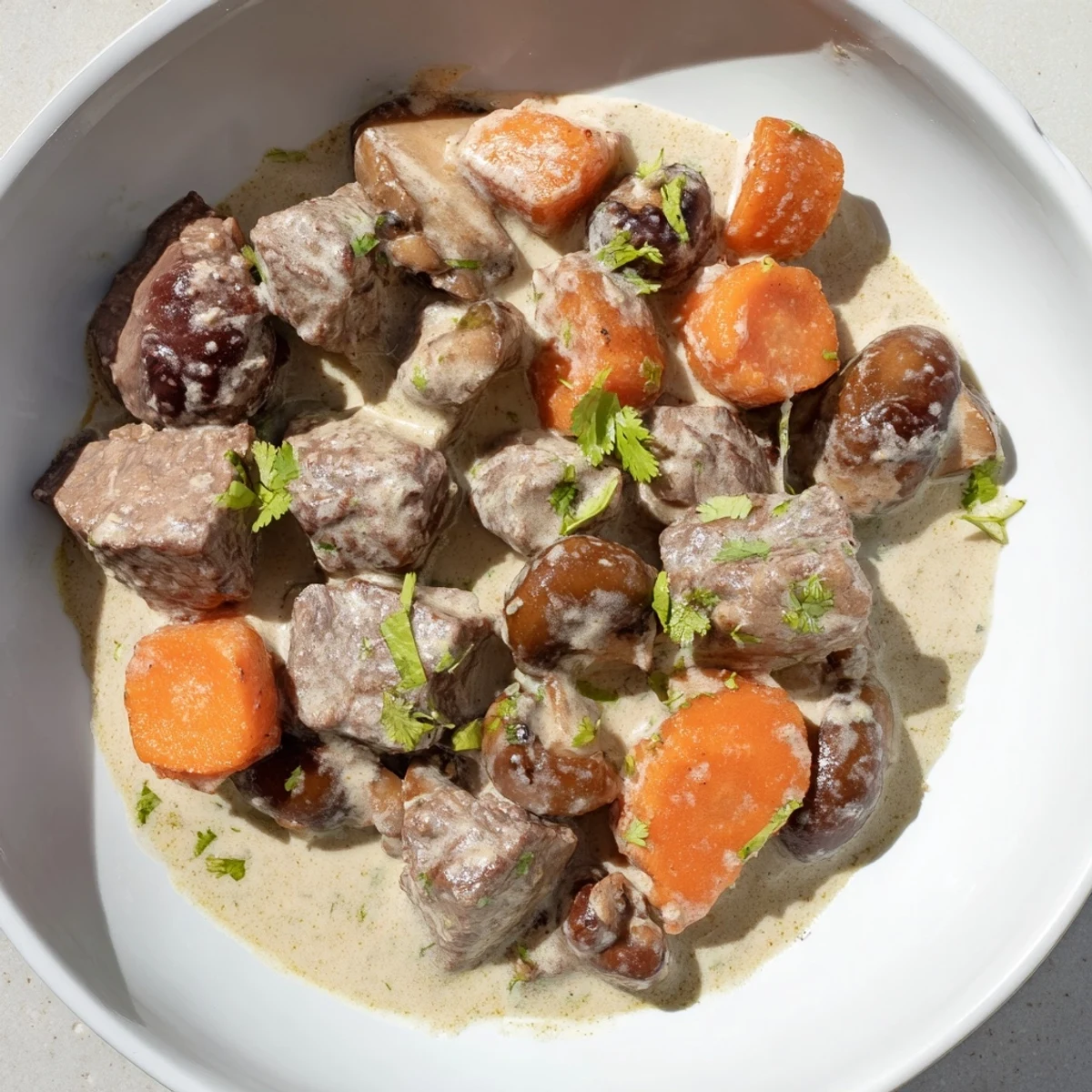 Aromatic Lemongrass Coconut Braised Beef with Mushrooms topped with fresh cilantro and lime wedges.