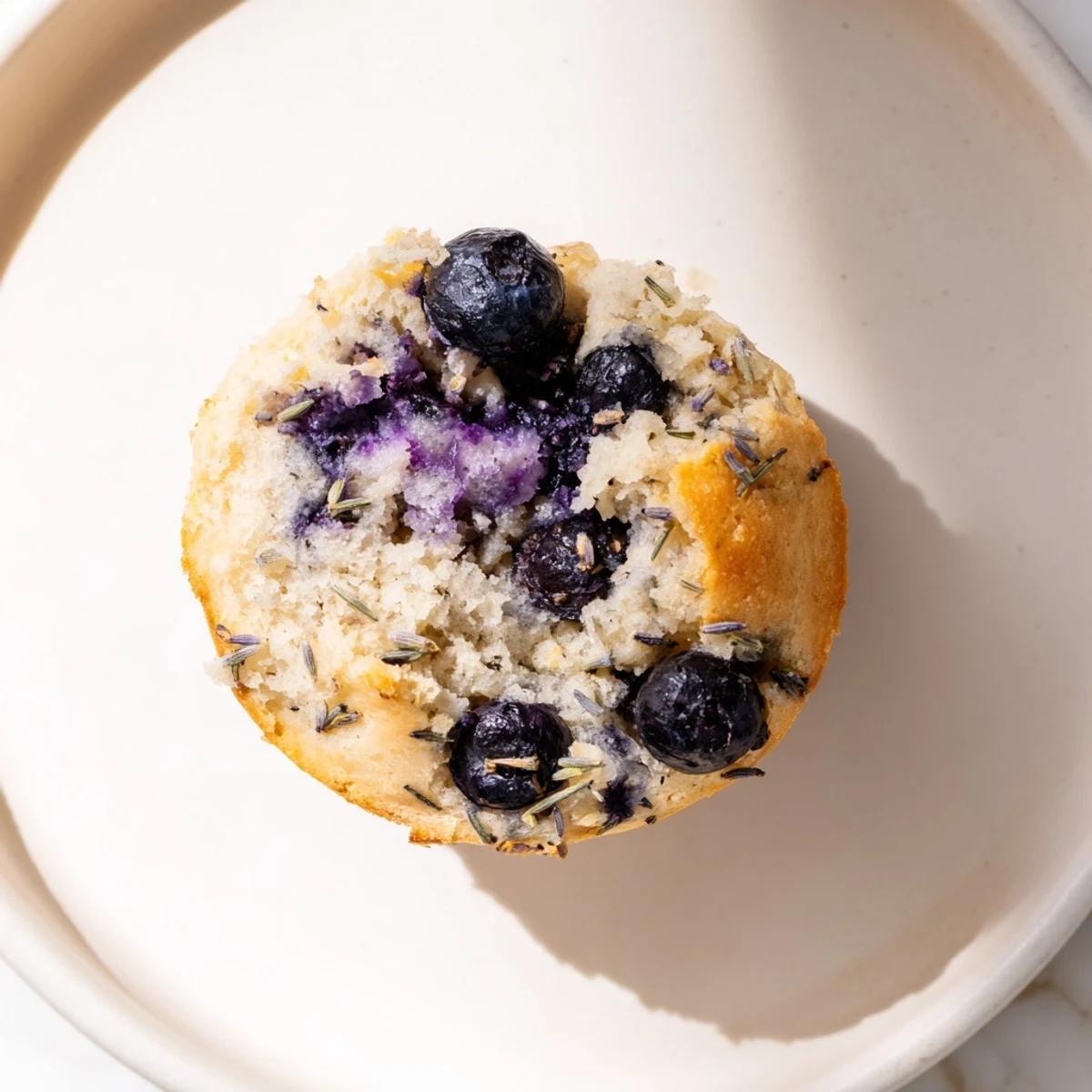 A close-up of Lavender Blueberry Tea Cakes, studded with plump blueberries and dusted with sugar, ready to enjoy.