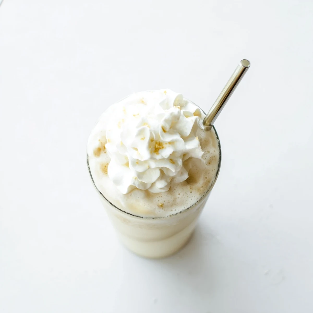 Creamy Starbucks Vanilla Bean Frappuccino topped with whipped cream in a tall glass, perfect refreshing summer beverage.