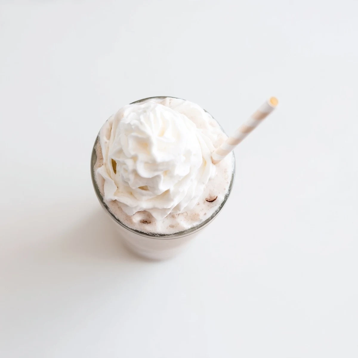 Cold and creamy Starbucks Vanilla Bean Frappuccino with whipped cream swirl, ideal sweet treat for hot afternoons.