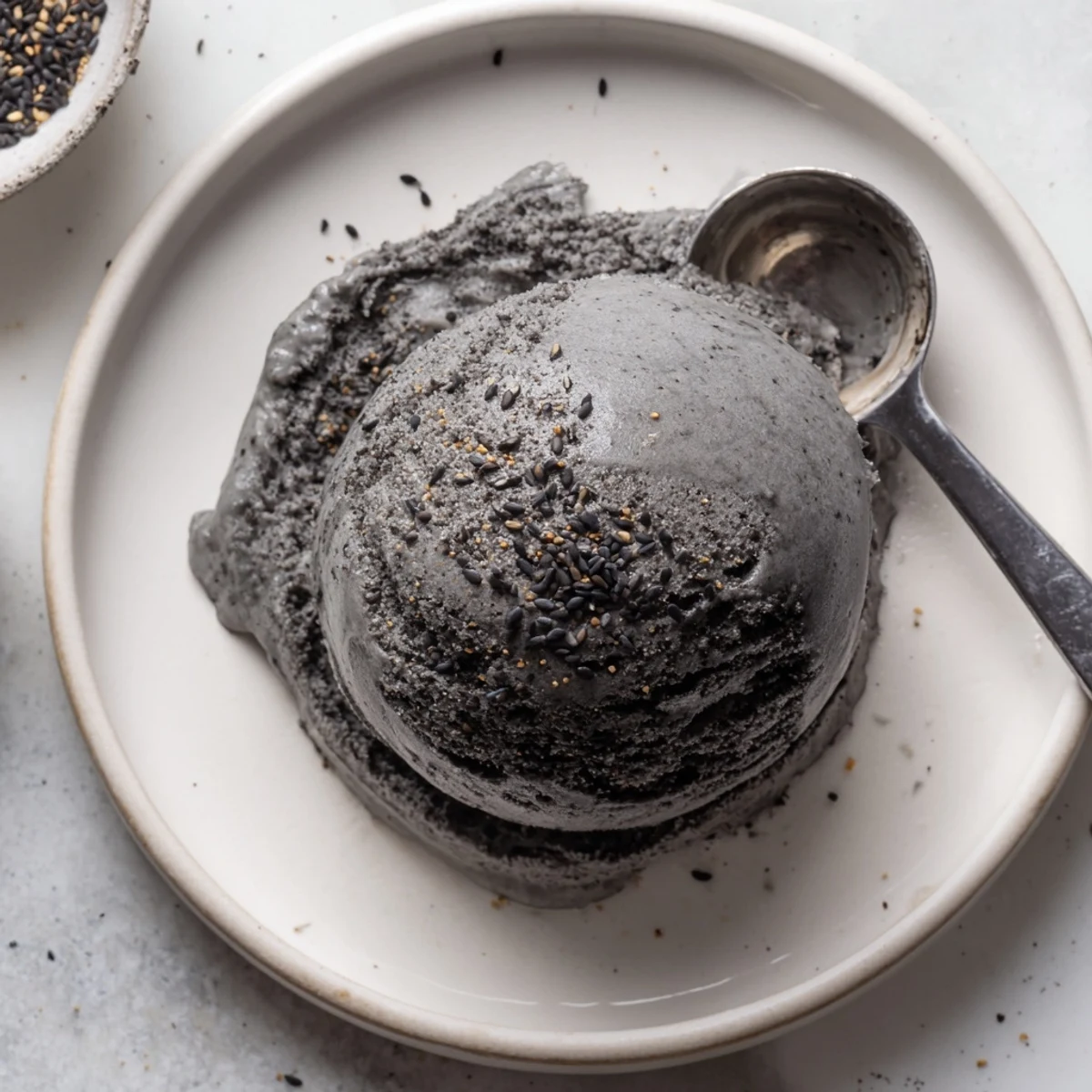 Homemade black sesame ice cream served in waffle cones with a swirl of sesame paste.