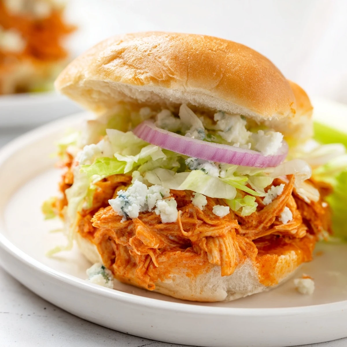 Golden toasted slider buns filled with tender spicy Buffalo chicken, crisp lettuce, and creamy blue cheese crumbles.