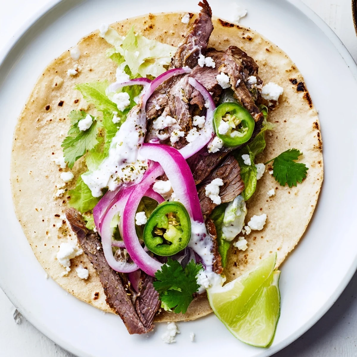 Golden-brown cumin crusted leg of lamb with tacos, sliced thin on a rustic wooden board, surrounded by fresh cilantro, red onion, and lime wedges.