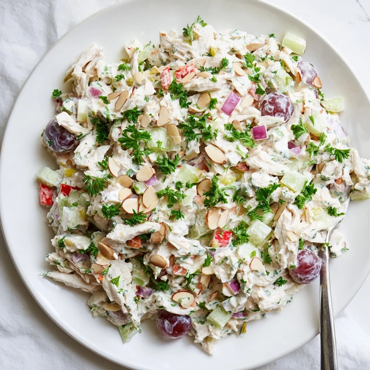 Tender shredded rotisserie chicken mixed with Greek yogurt dressing, red bell pepper, celery, and parsley.