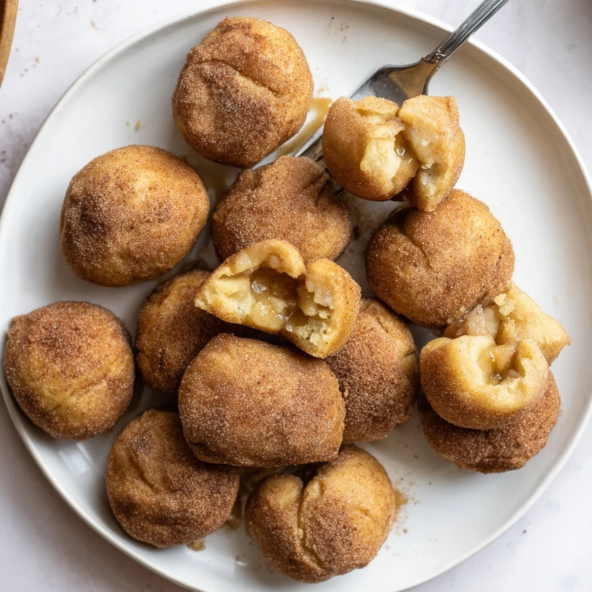 Warm caramel apple pie bombs sprinkled with cinnamon sugar and stuffed with gooey caramel candy