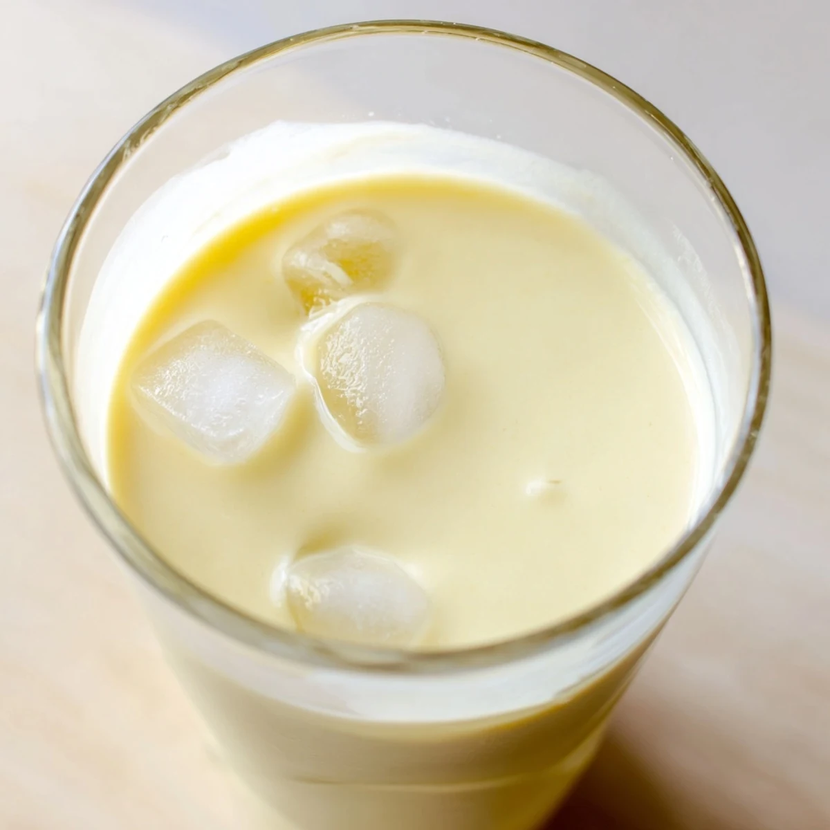 Creamy durian smoothie blended with banana and coconut milk in a chilled glass