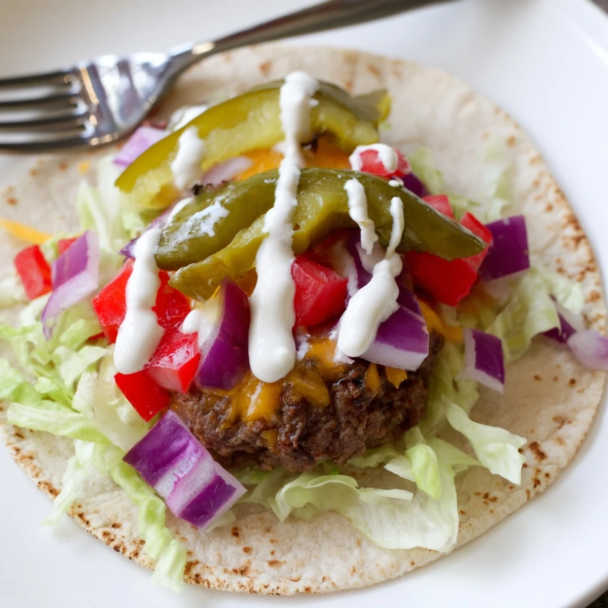 Crispy-edged smash burger tacos loaded with melted American cheese and creamy burger sauce drizzle