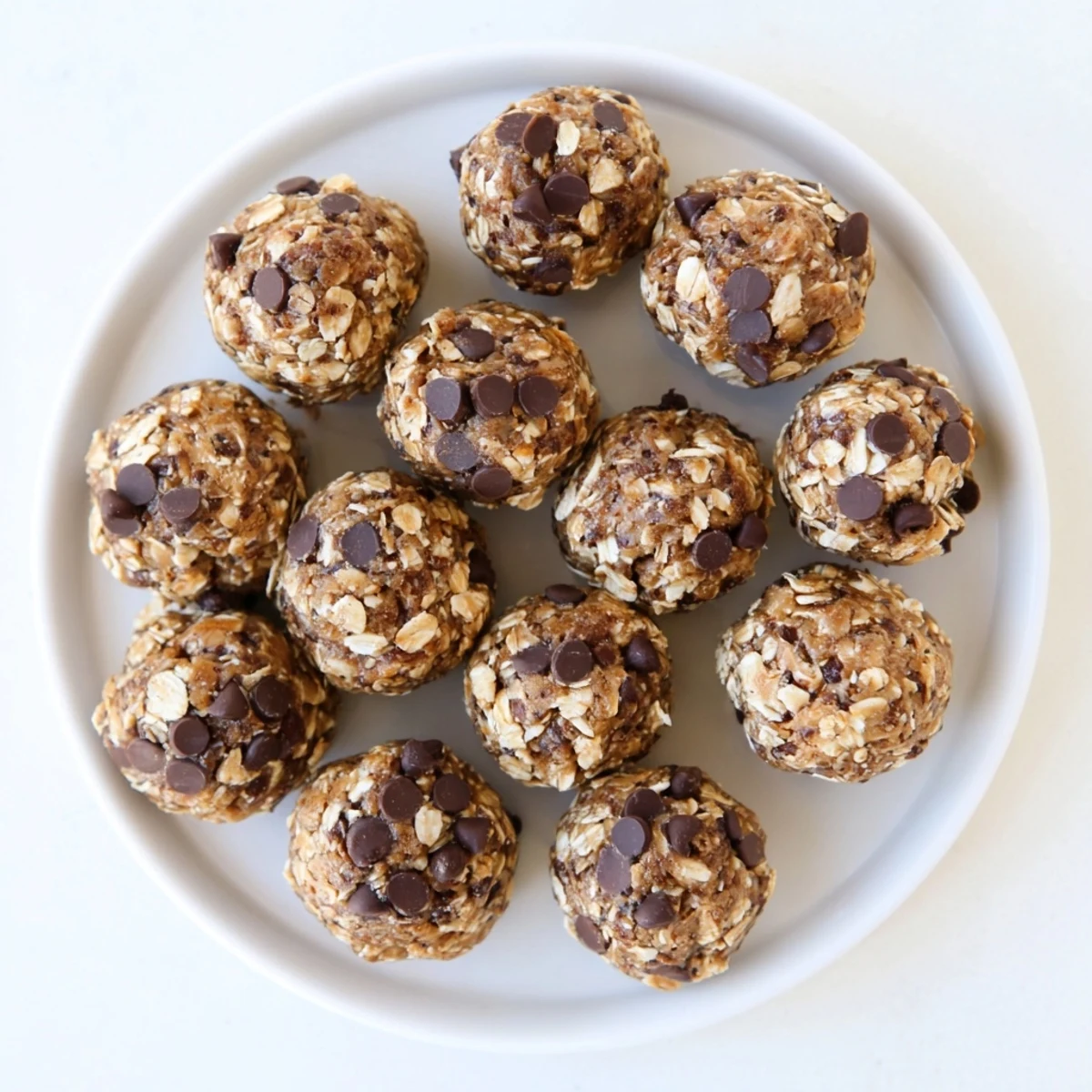 Rich chocolate peanut butter protein balls with visible oats and chocolate chunks ready to eat