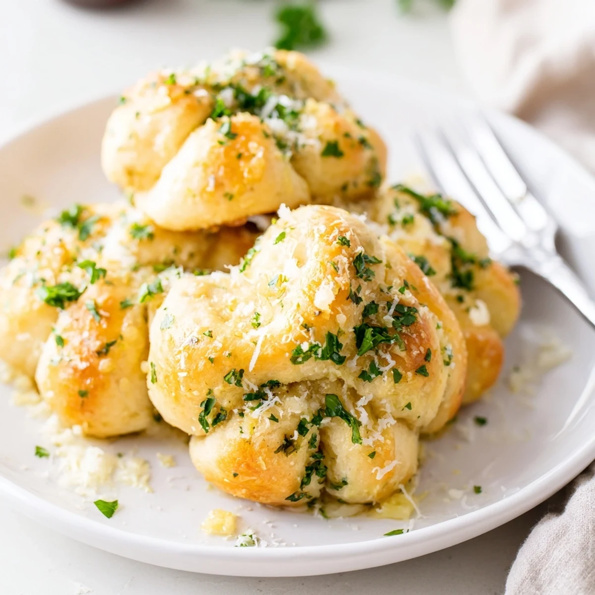 Basket of warm gluten-free garlic knots tied into classic shapes, ready for dipping into marinara sauce