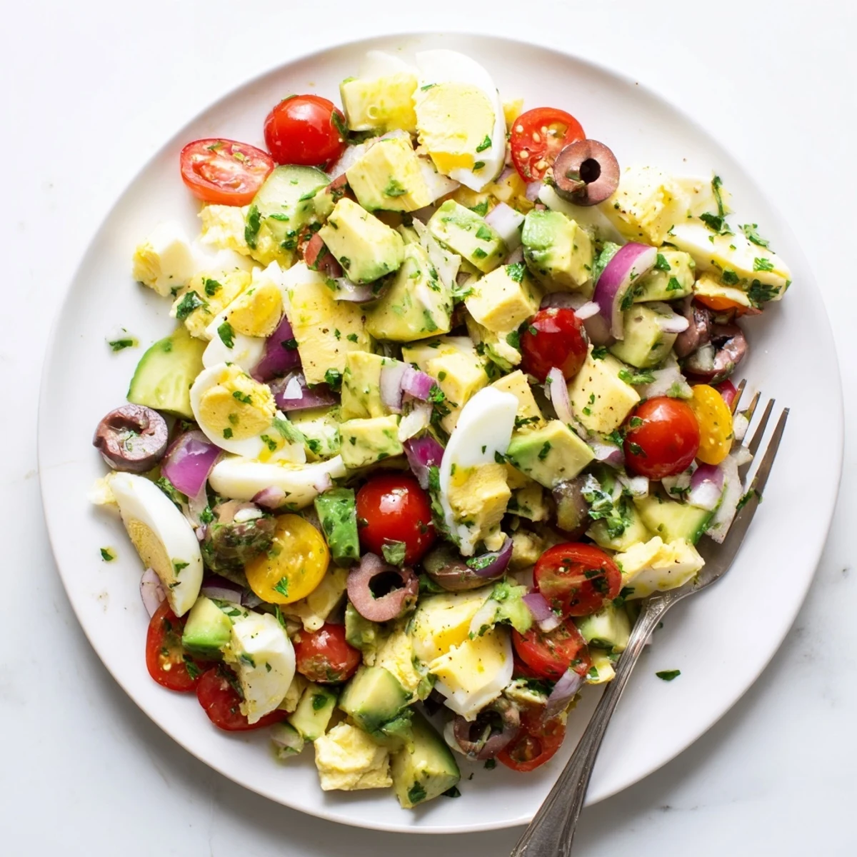 Close-up of chunky Mediterranean avocado egg salad with crisp cucumber and red onion pieces