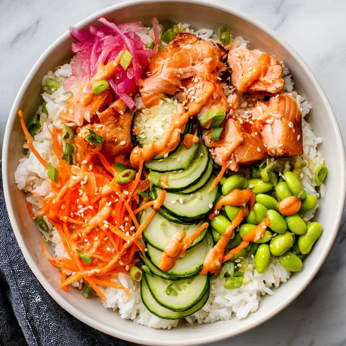 Vibrant easy salmon bowl featuring tender fish, colorful vegetables, and spicy sriracha mayonnaise drizzle