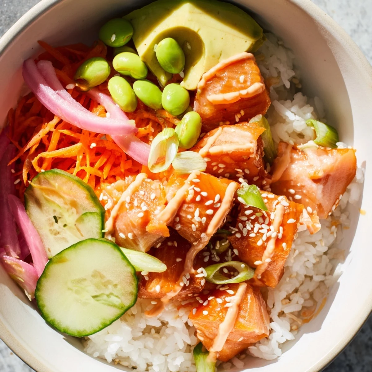 Close-up of nutritious salmon bowl with edamame, carrots, and sesame seed topping