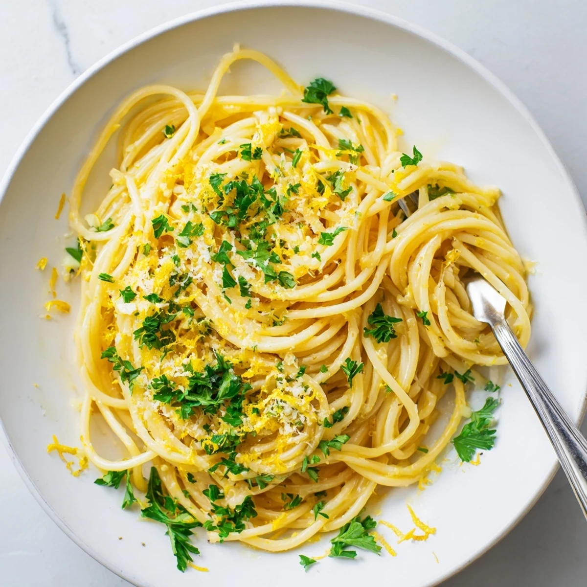 Creamy one pot garlic butter pasta tossed with parmesan and fresh parsley in a rustic bowl
