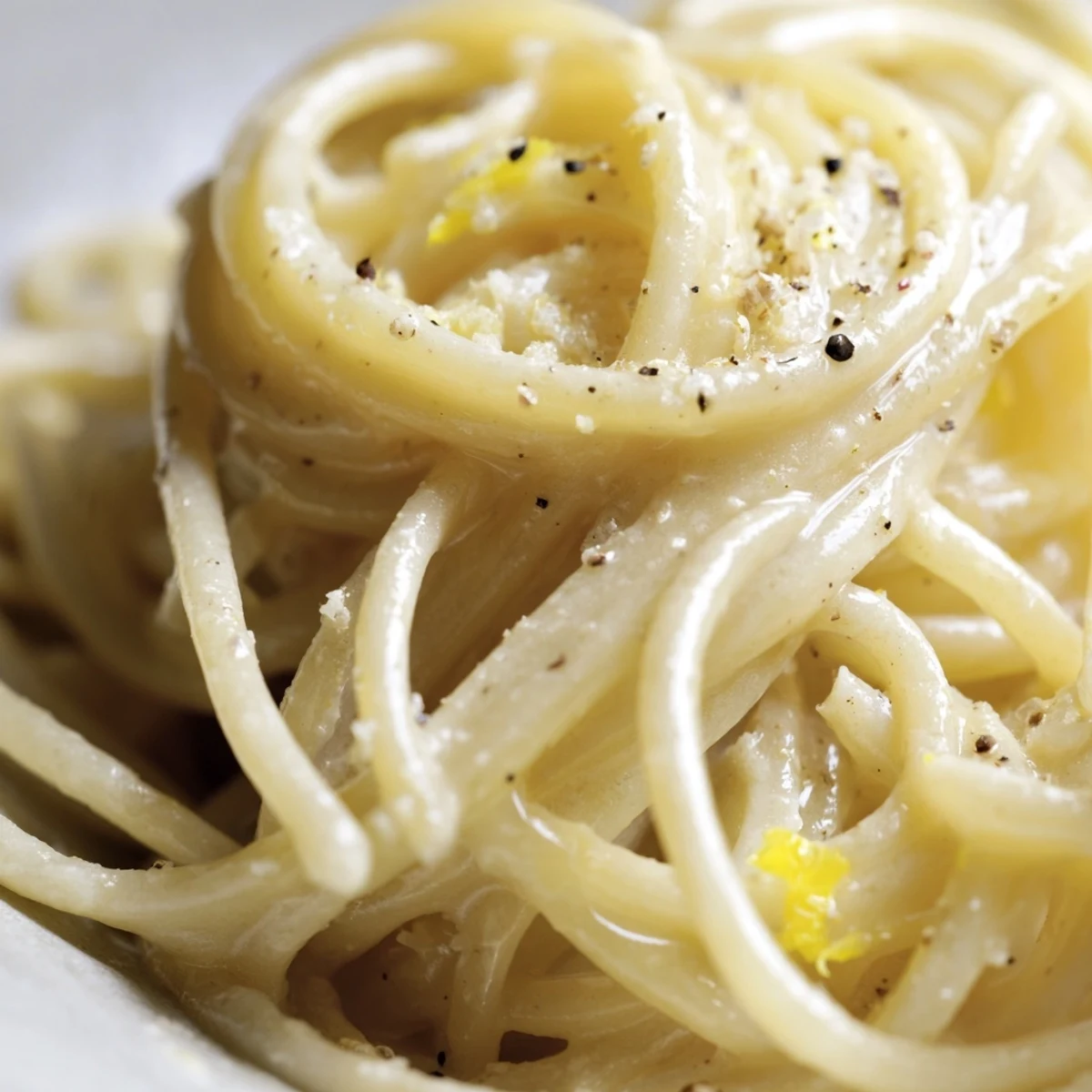 Golden buttery Parmesan lemon pasta twirled on a plate ready to serve