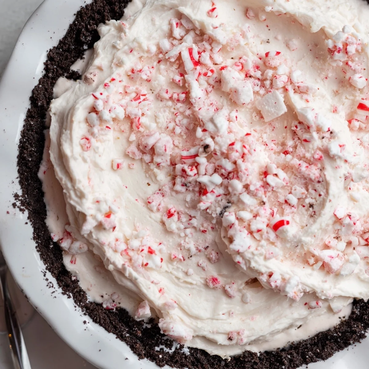 Candy Cane Pie with creamy peppermint filling and chocolate cookie crust, ready to serve.
