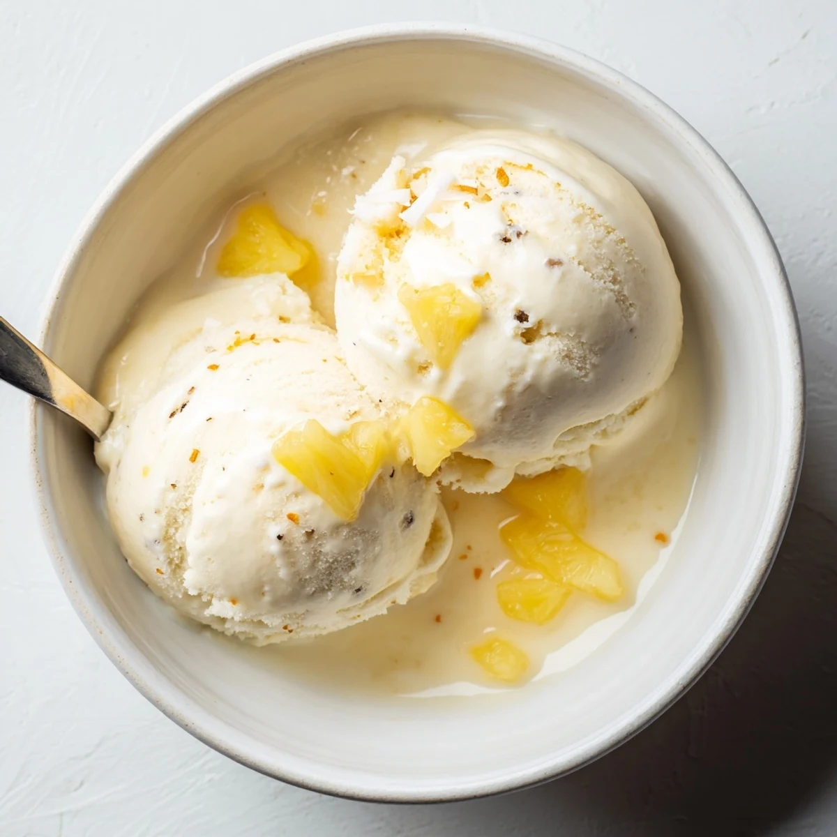 Serving suggestion: Creamy Pineapple Ice Cream with toasted coconut and rum drizzle