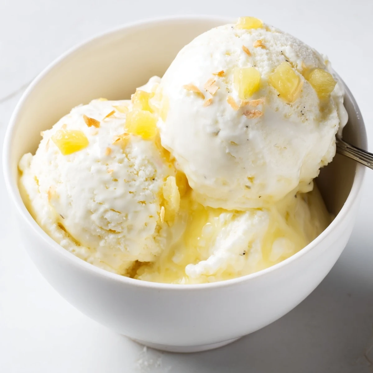 Homemade Creamy Pineapple Ice Cream chilling in freezer-safe container, ready to scoop