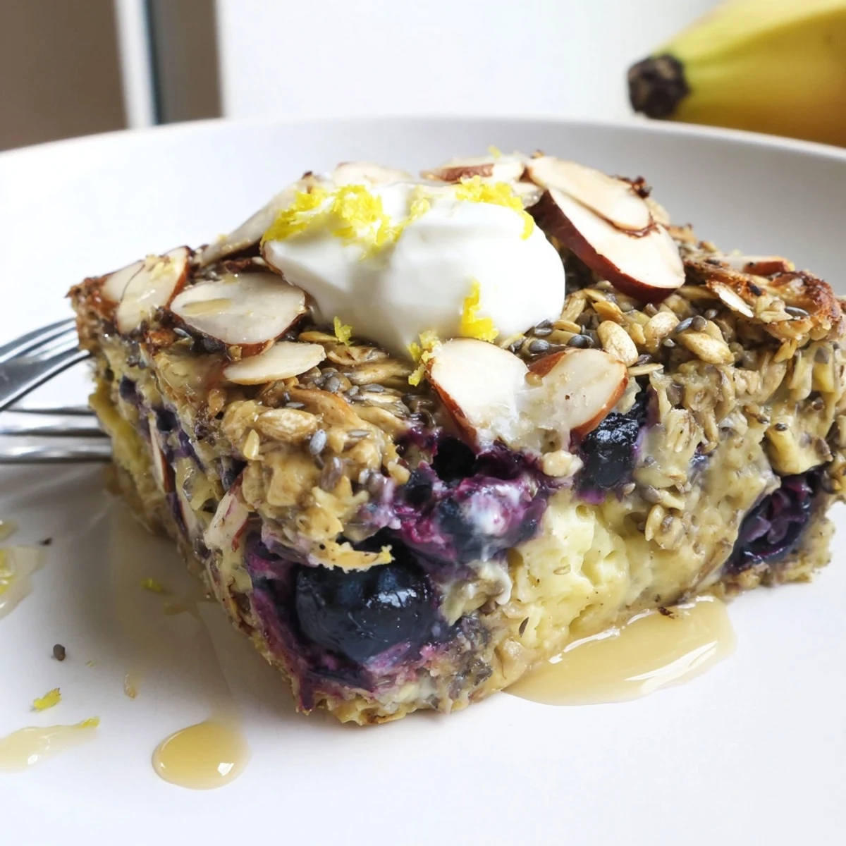High Protein Lemon Blueberry Breakfast Bake steaming in dish, golden edges.