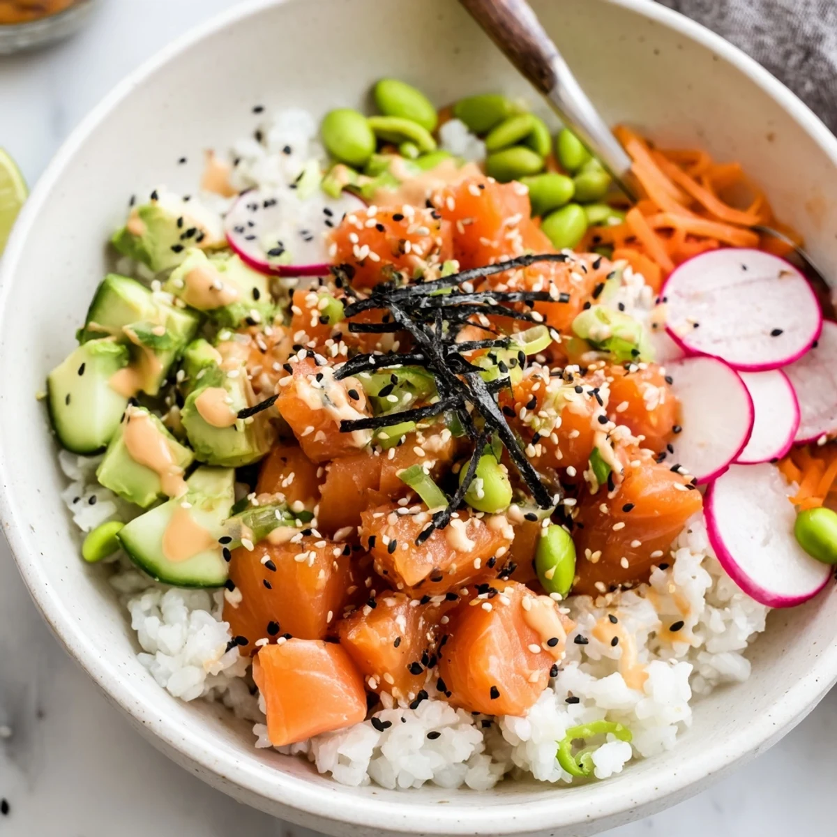 Salmon And Avocado Poke Bowl with glossy marinated salmon, creamy avocado, lime  
