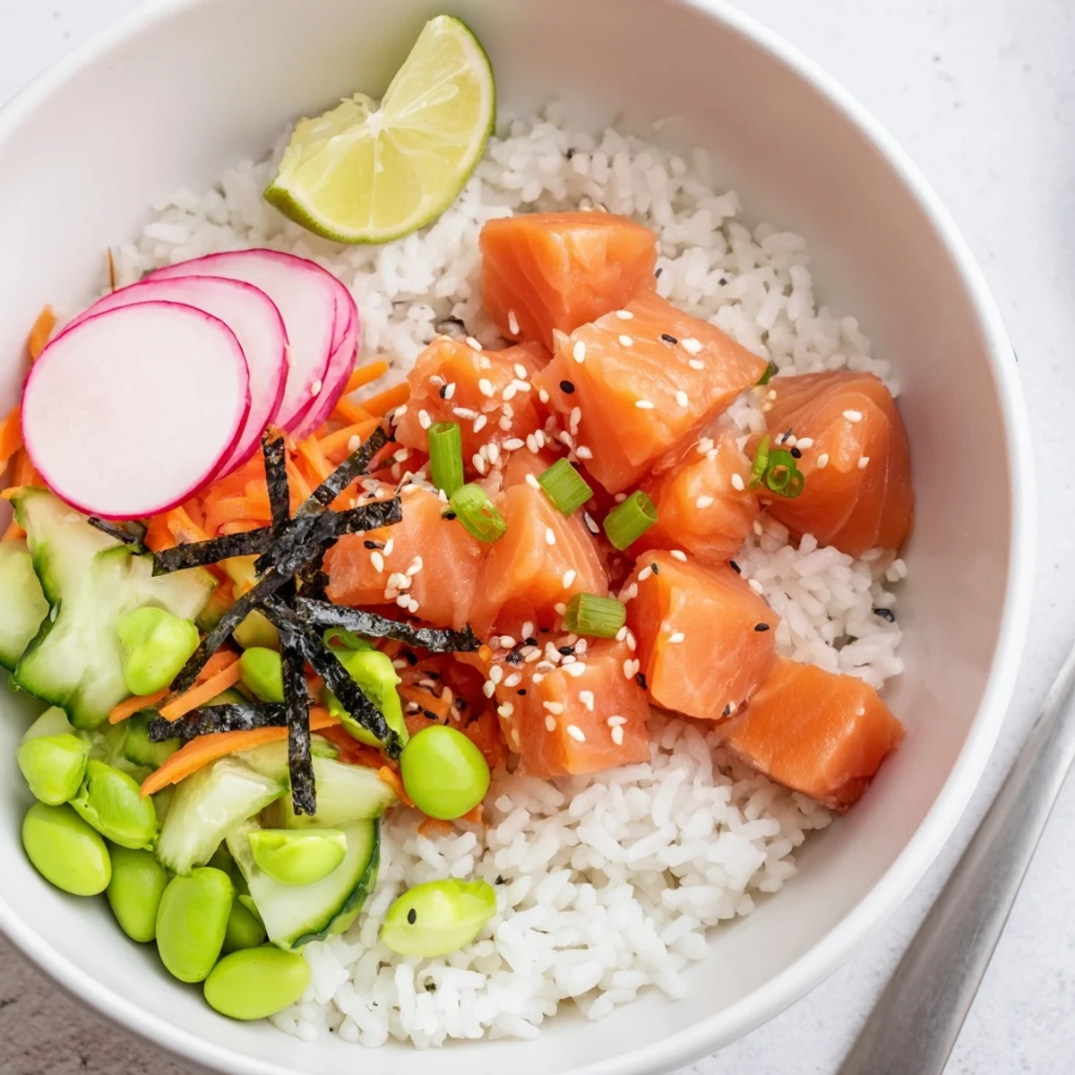 Chilled Salmon And Avocado Poke Bowl garnished with radishes, pickled ginger