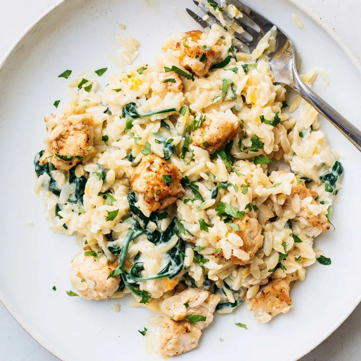 Golden one pan Boursin chicken orzo with tender spinach in a creamy white sauce