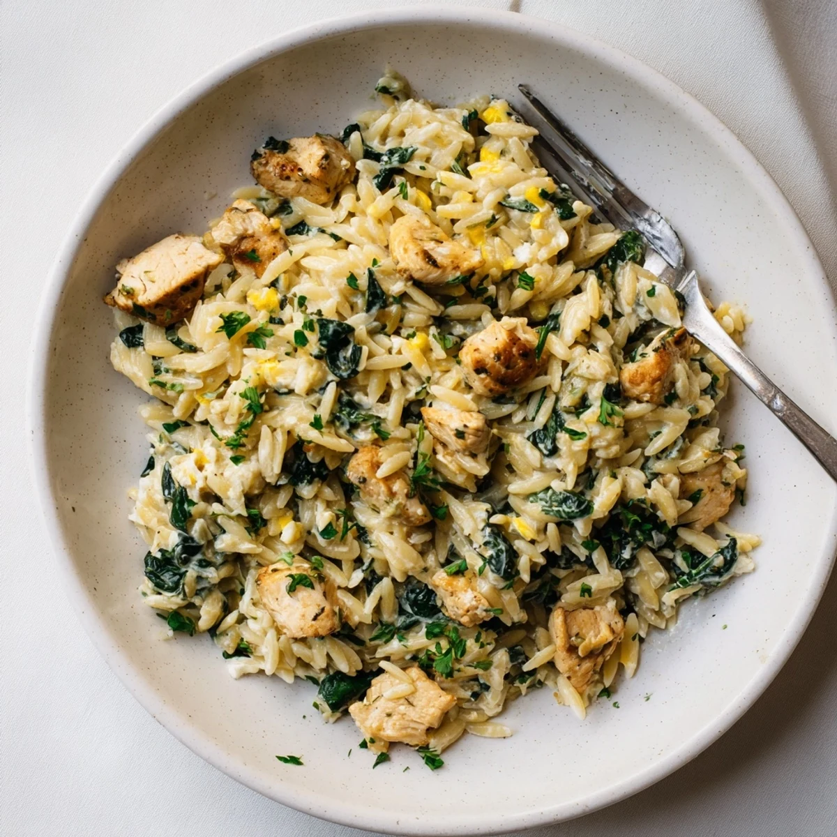 Creamy one pan Boursin chicken orzo simmers with fresh wilted spinach and herbs