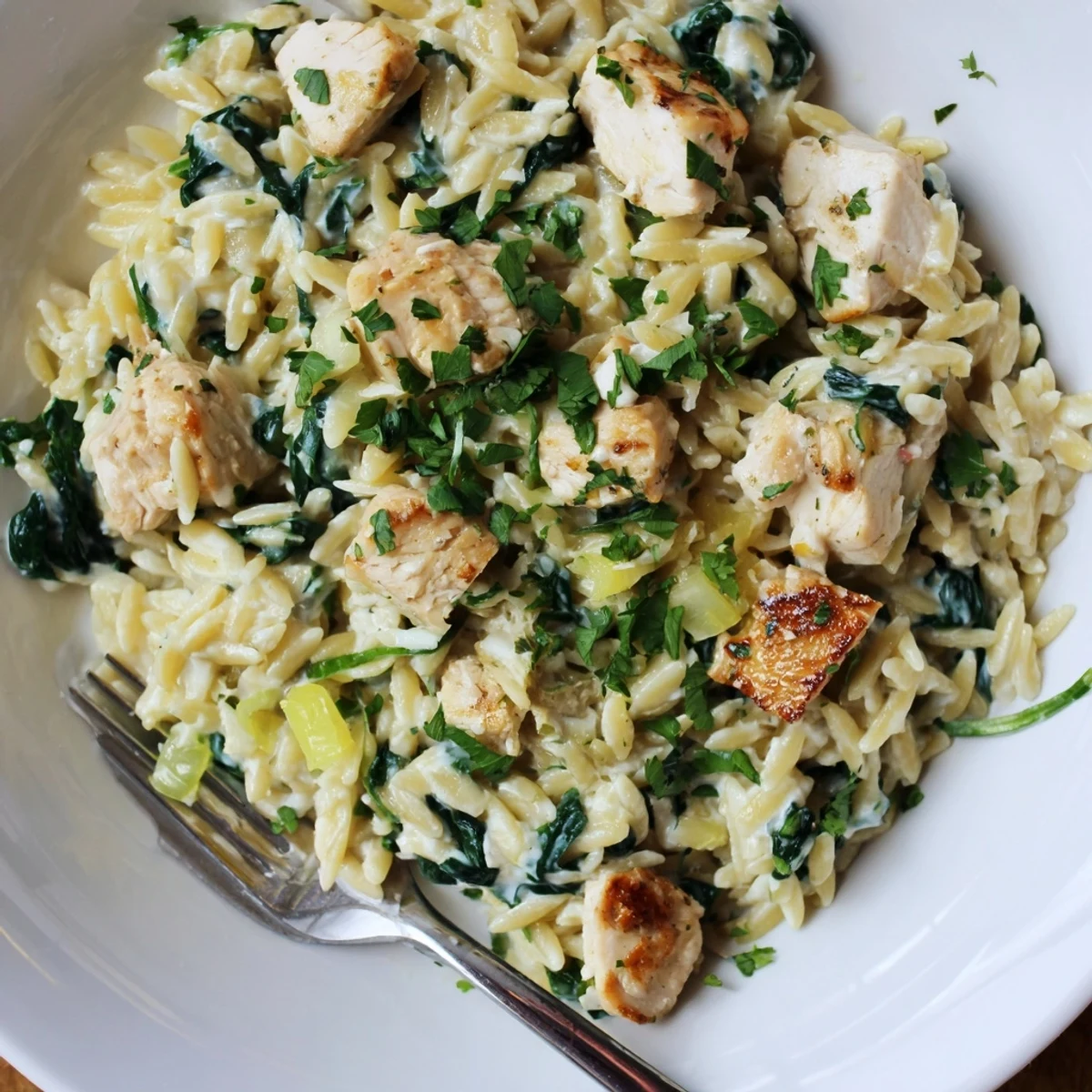 Savory one pan Boursin chicken orzo features melting cheese and bright green spinach