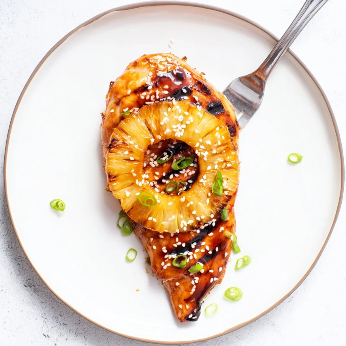 Smoky Grilled Aloha Chicken sliced on platter, garnished with scallions and sesame.