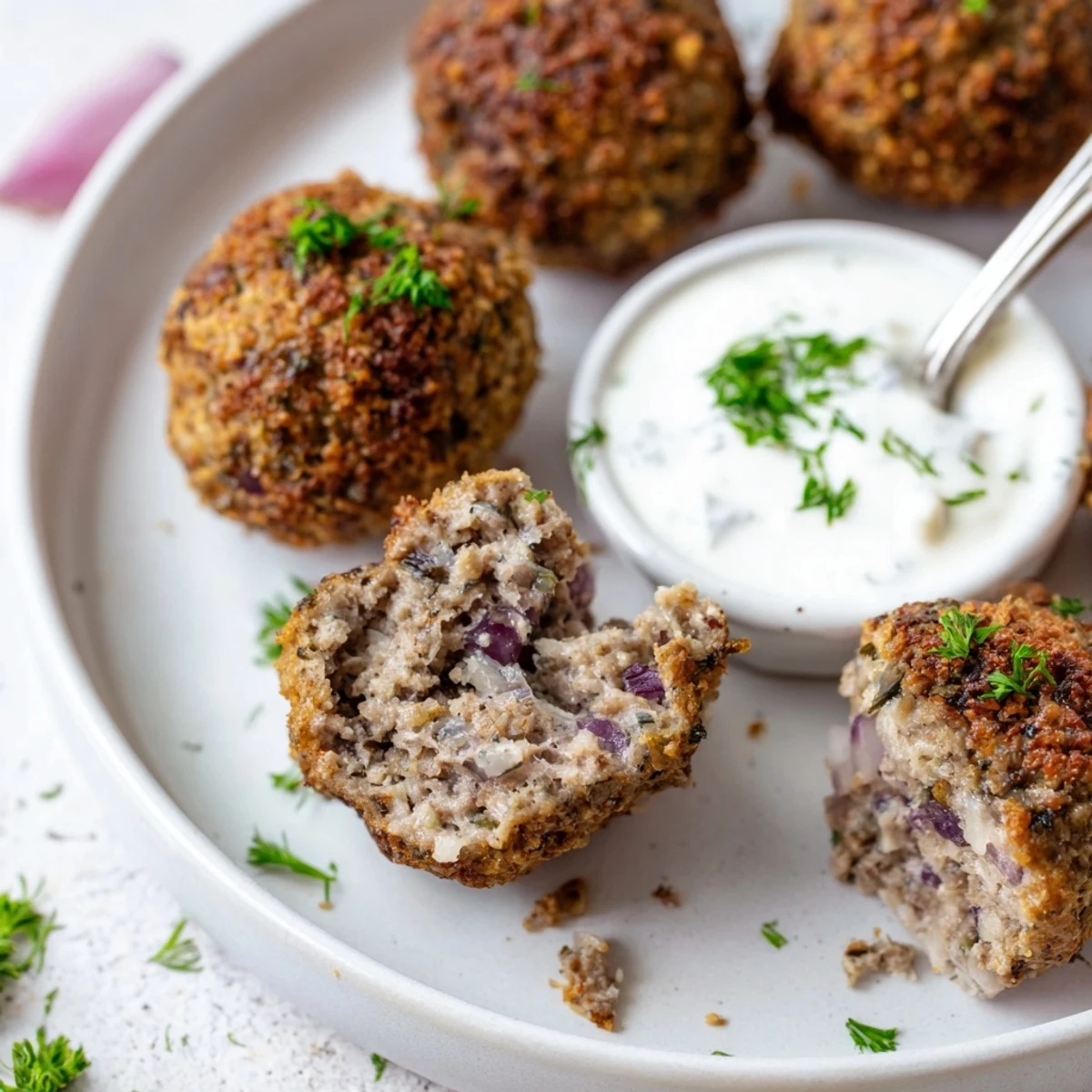 Warm Greek Style Beef Meatballs garnished with parsley, perfect for pita dipping