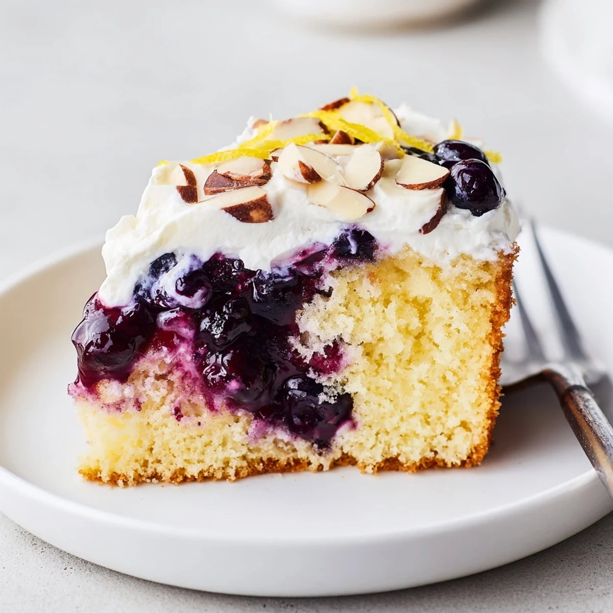 Refrigerated Lemon Blueberry Poke Cake With Almond Topping served with tea, creamy almonds.
