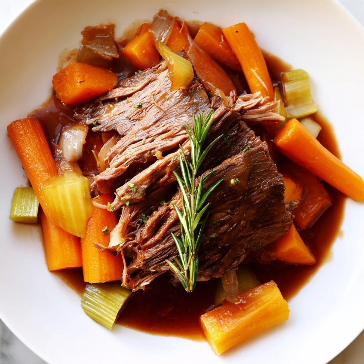 Tender perfect pot roast with carrots and onions in rich savory gravy