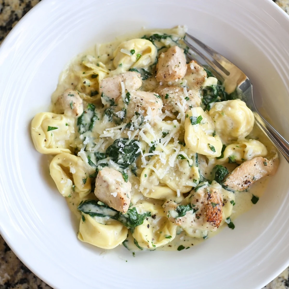 Golden seared chicken and cheese tortellini tossed in a rich garlic cream sauce
