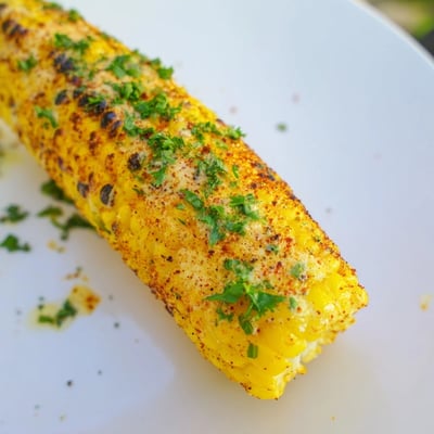 Golden Corn on the Cob with Cajun Spices fresh from the grill, featuring charred kernels and a bold, buttery spice coating for a Southern side dish.
