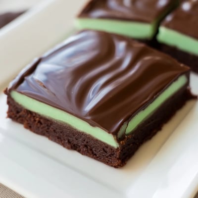 Overhead view of Green Mint Brownies squares, featuring fudgy texture and a cooling mint cream center.
